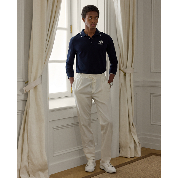 These trousers' Italian satin fabric was custom-developed using a cotton blend that includes silk and a hint of stretch. Constructed with an elastic drawstring waistband, they combine the look of traditional tailoring with the modern comfort of Purple Label sportswear.