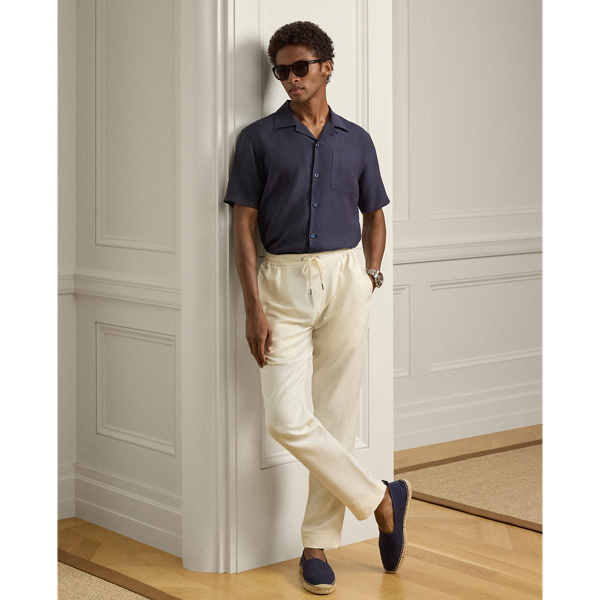 These pleated trousers are hand-tailored using a lightweight cloth that was custom-developed for  Ralph Lauren Lauren. Woven with textured silk and fine linen, the Italian fabric is washed prior to construction and offers a soft, vintage-inspired effect.