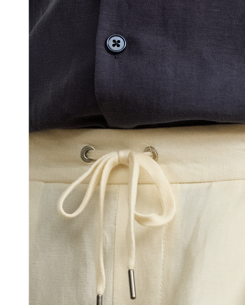 These pleated trousers are hand-tailored using a lightweight cloth that was custom-developed for  Ralph Lauren Lauren. Woven with textured silk and fine linen, the Italian fabric is washed prior to construction and offers a soft, vintage-inspired effect.